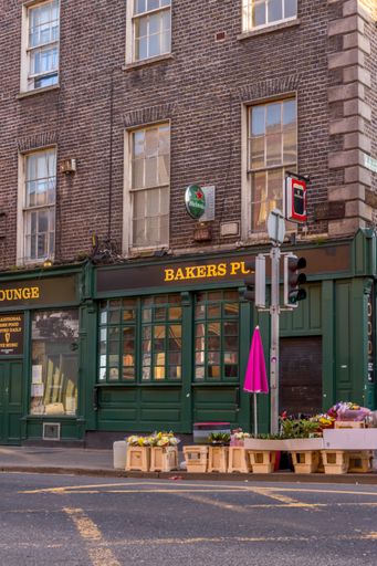 Ireland, Dublin, a side view of Bakers lounge pub in the corner of the street flowers in front