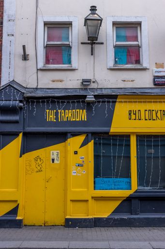 Ireland, Dublin, a street view of closed taproom The Drop Dead Twice with gray and yellow colours