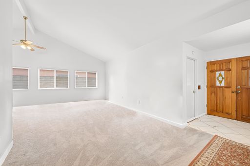 Various rooms of a suburban home including bedrooms, bathrooms, kitchen, and open living spaces with vaulted ceilings and ceiling fans.