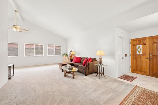 Various rooms of a suburban home including bedrooms, bathrooms, kitchen, and open living spaces with vaulted ceilings and ceiling fans.