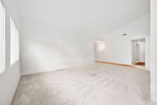 Various rooms of a suburban home including bedrooms, bathrooms, kitchen, and open living spaces with vaulted ceilings and ceiling fans.