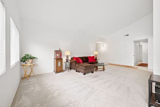 Various rooms of a suburban home including bedrooms, bathrooms, kitchen, and open living spaces with vaulted ceilings and ceiling fans.