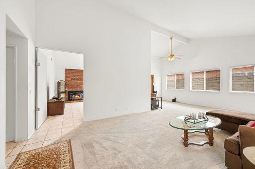 Various rooms of a suburban home including bedrooms, bathrooms, kitchen, and open living spaces with vaulted ceilings and ceiling fans.