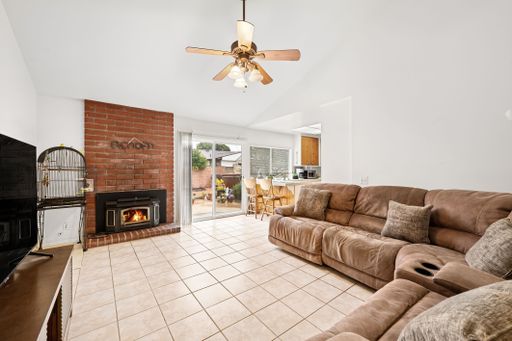 Various rooms of a suburban home including bedrooms, bathrooms, kitchen, and open living spaces with vaulted ceilings and ceiling fans.