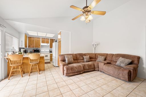 Various rooms of a suburban home including bedrooms, bathrooms, kitchen, and open living spaces with vaulted ceilings and ceiling fans.