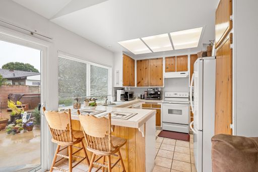 Various rooms of a suburban home including bedrooms, bathrooms, kitchen, and open living spaces with vaulted ceilings and ceiling fans.