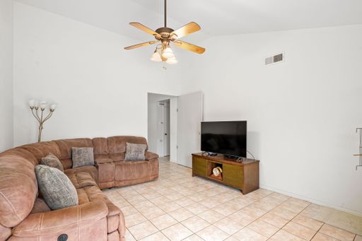 Various rooms of a suburban home including bedrooms, bathrooms, kitchen, and open living spaces with vaulted ceilings and ceiling fans.