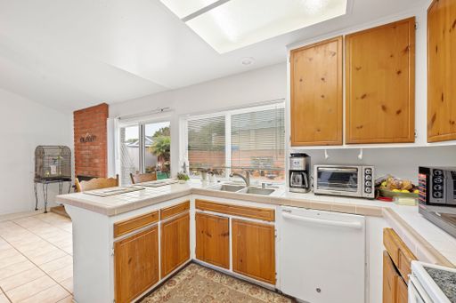 Various rooms of a suburban home including bedrooms, bathrooms, kitchen, and open living spaces with vaulted ceilings and ceiling fans.