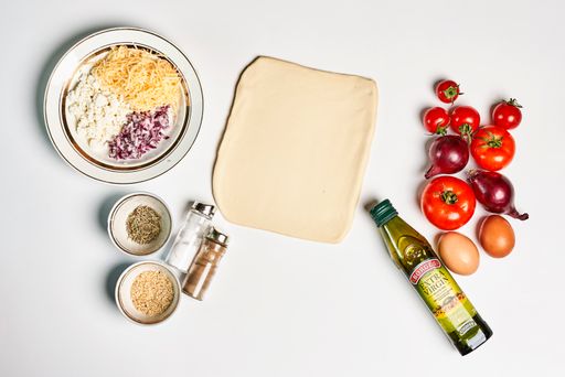 A top view of pizza ingredients isolated on white background