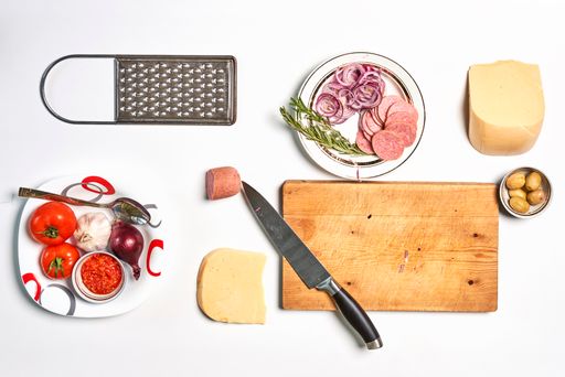 A top view of pizza ingredients isolated on white background