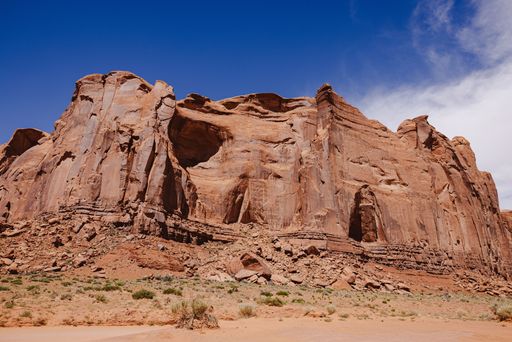 A striking view of Monument Valley's red rock formations under a vibrant blue sky.