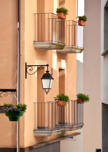 A vertical shot of a residential building in Andorra decorated with flowers