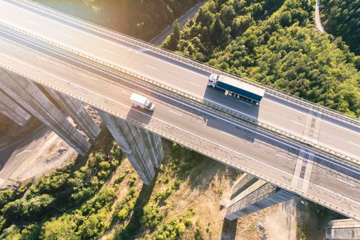 two different size cargo delivery truck drive on highway drone