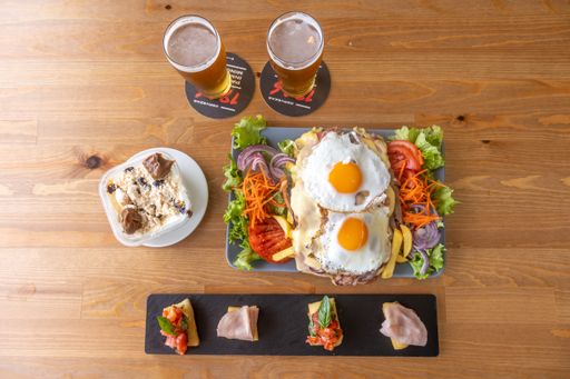 A closeup shot of tasty classic Korean dish served in a restaurant with glasses of beers