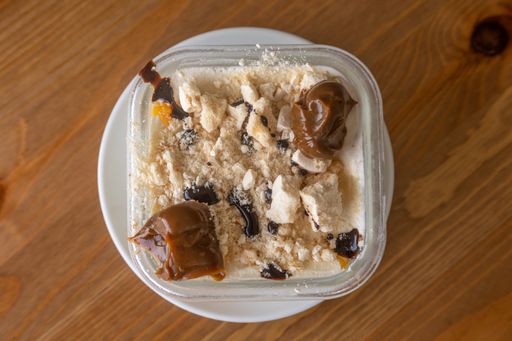 A closeup shot of a coffee ice cream on a clear plastic container