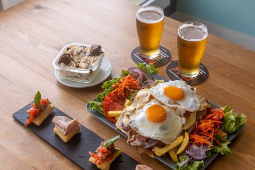 A closeup shot of tasty classic Korean dish served in a restaurant with glasses of beers