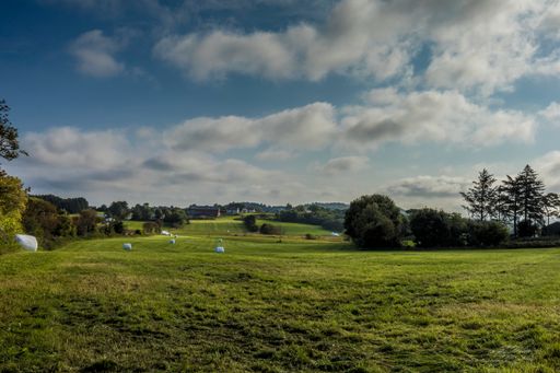 A beautiful view of a landscape with greenery under a cloudy sky