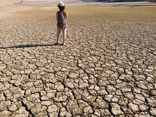A rear view of a female on the dried-up Penne dam in Abruzzo, Italy on a sunny day