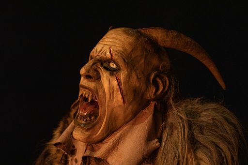 A closeup shot of a male wearing a Halloween costume isolated on a black background