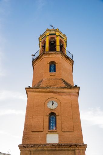 A low-angle shot of a temple against the blue sky in Spain