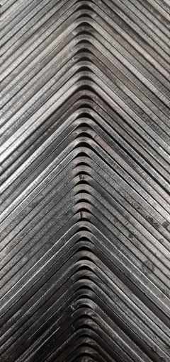 A vertical shot of a curved metal texture