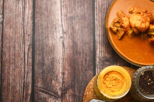 A top view of a meal cooked with chicken and various seasonings on a table