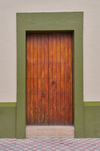 Antique dry green painted wood door facade with copy space