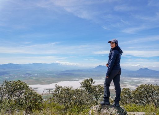 Hispanic woman standing on a rock on the mountain in Puebla, Mexico