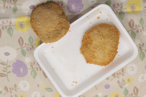 An overhead shot of chicken steaks drenched with cheese and fried Cordon Bleu