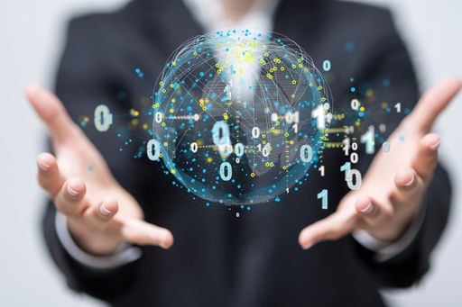 A hologram of binary codes around a globe between the palms of a businessman