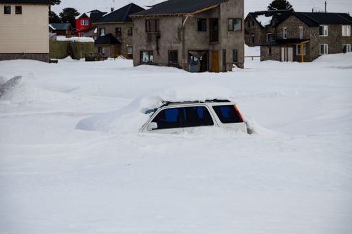 A Car covered with snow after a snowfall