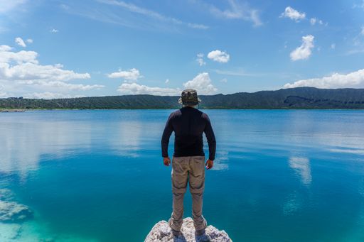 A hispanic man looking at Laguna De San Luis Atexcac in Puebla, Mexico
