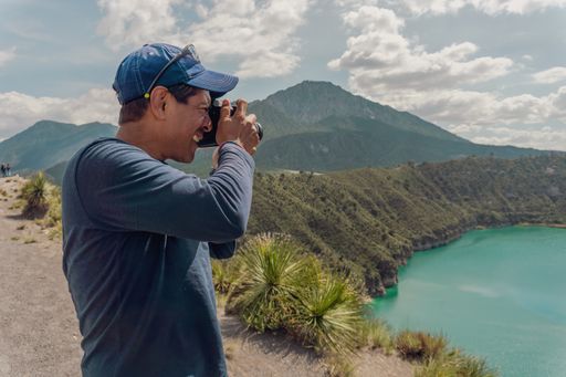 A focus view of a man taking pictures of Laguna De San Luis Atexcac in Mexico