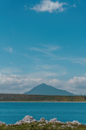 A vertical shot of Lagoon Alchichica with an inactive stratovolcano Pice de Orizaba in the background in Mexico