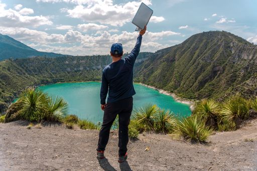 A Hispanic man celebrating his achievement looking to Laguna De San Luis Atexcac in Mexico