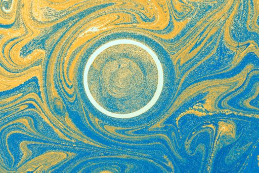 The abstract blue and gold mixed color texture with a round center