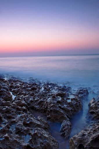 A vertical shot of the Praia da Foz beach during sunset