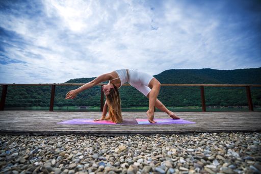 A woman doing yoga on the beach