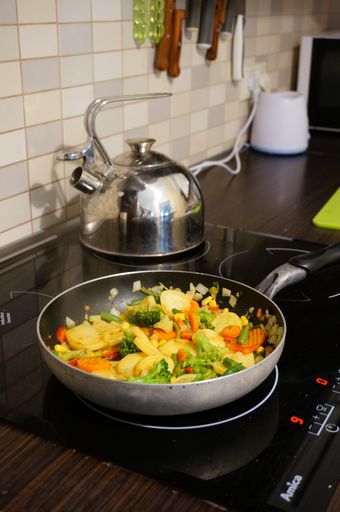 A vertical shot of fried vegetables in a pan