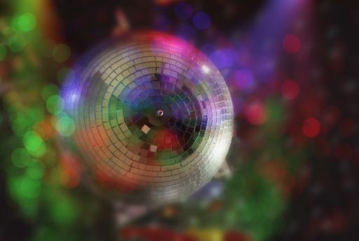 A horizontal shot of Blur Mirrored Disco Ball Background with Colorful Bokeh