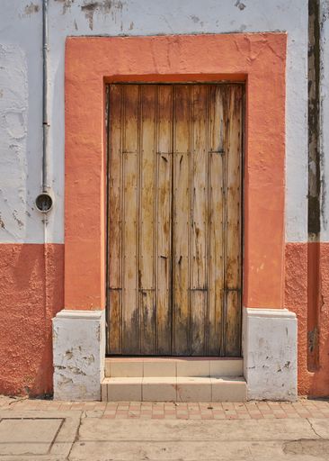 Antique wooden door facade with paint wear with copy space