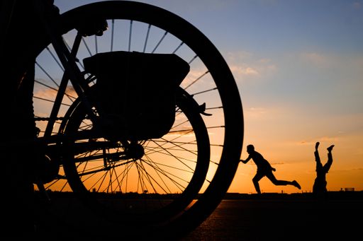 Silhouettes of people with the sunset in the background at the Tempelhofer Feld
