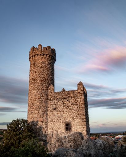 A vertical shot of The Watchtower of Torrelodones in Spain during sunset
