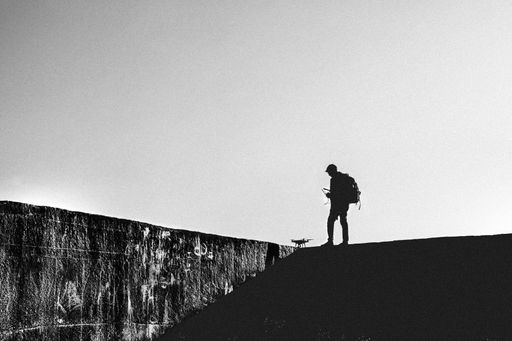 A silhouette shot of a lonely man with a backpack