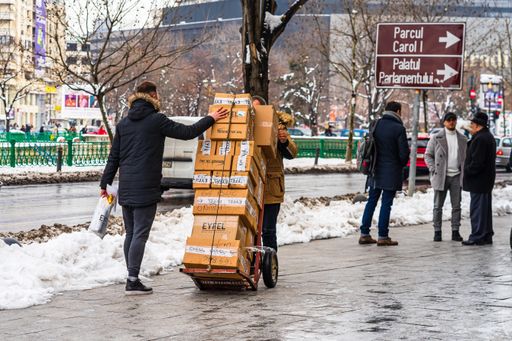 The people carrying cardboard boxes in Bucharest, Romania