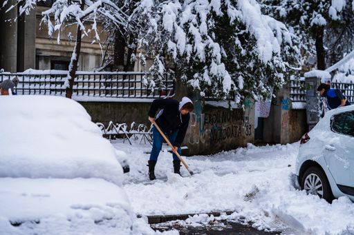 A worker cleaning the snowy road in Bucharest, Romania