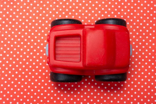 A top view shot of a red toy car