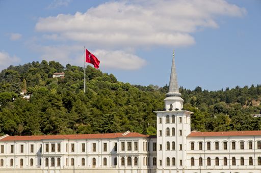 The Kuleli Military High School surrounded by hills covered in greenery under the sunlight in Turkey