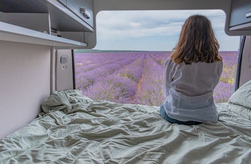 A woman looking at lavender fields from a camper