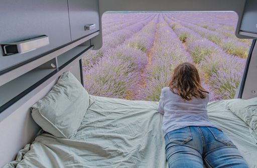 A woman looking at lavender fields from a camper